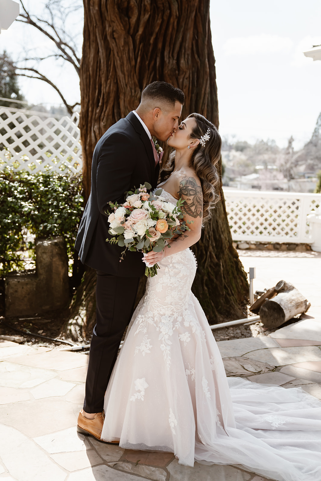 Bride and groom kiss at their Sequoia Mansion wedding first look