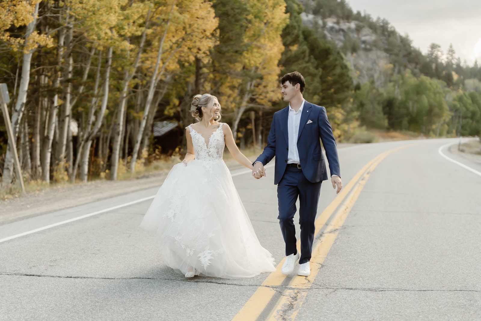 Bride and groom hold hands at Desolation Hotel