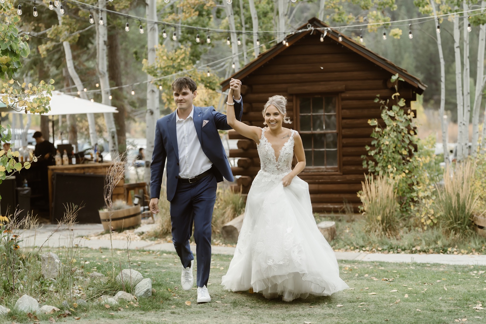 Bride and groom enter their outdoor Desolation Hotel wedding reception
