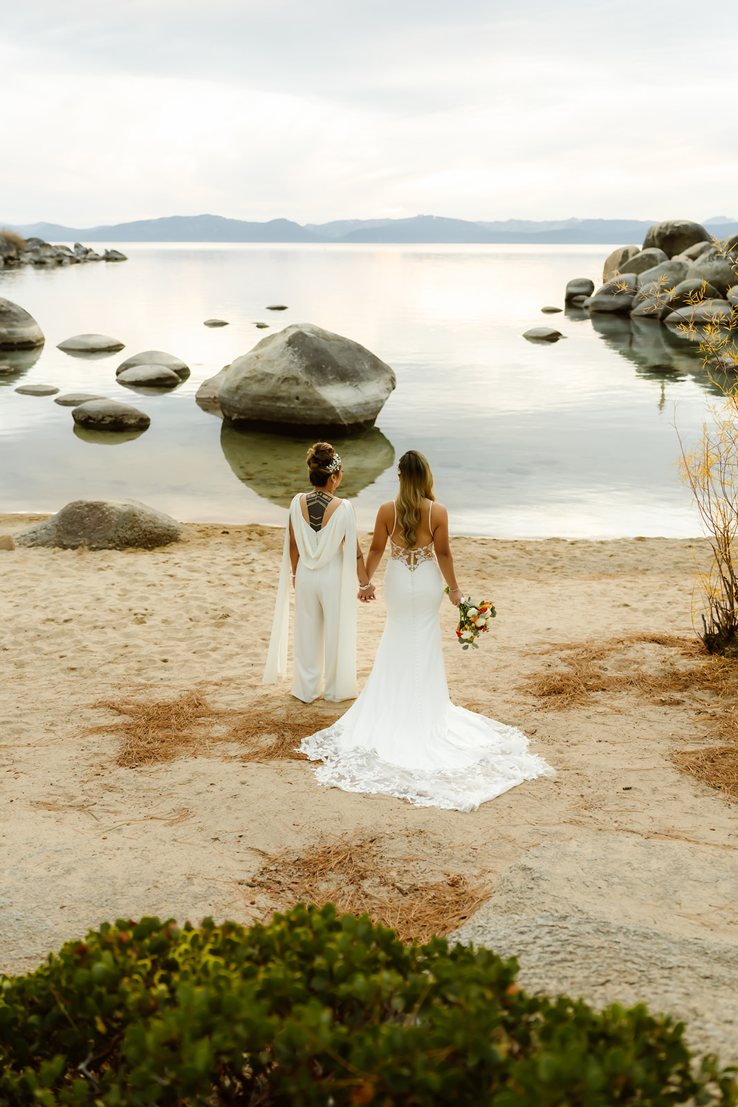 Brides hold hands at their LGBTQ elopement in Lake Tahoe