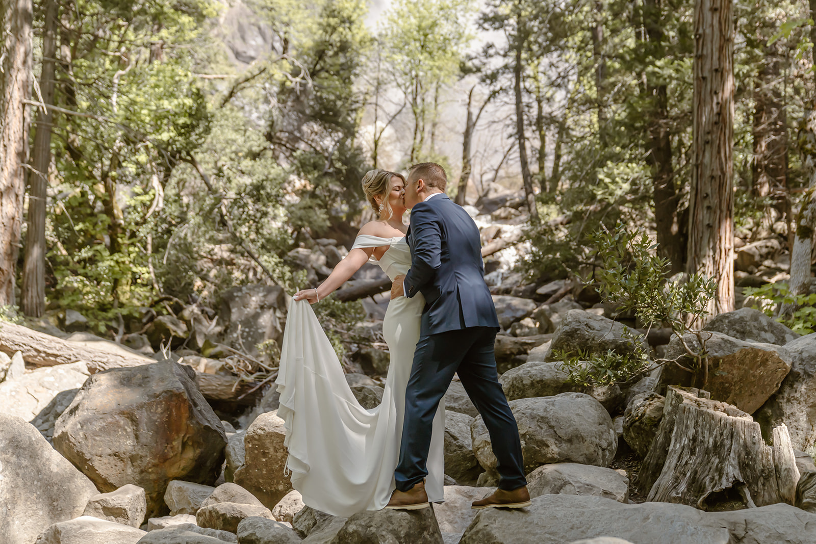 Man and woman kiss at Yosemite Falls