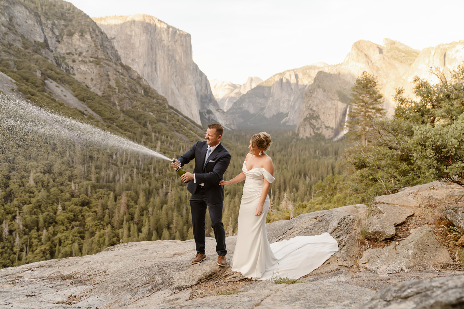 Couple pops champagne at Yosemite elopement