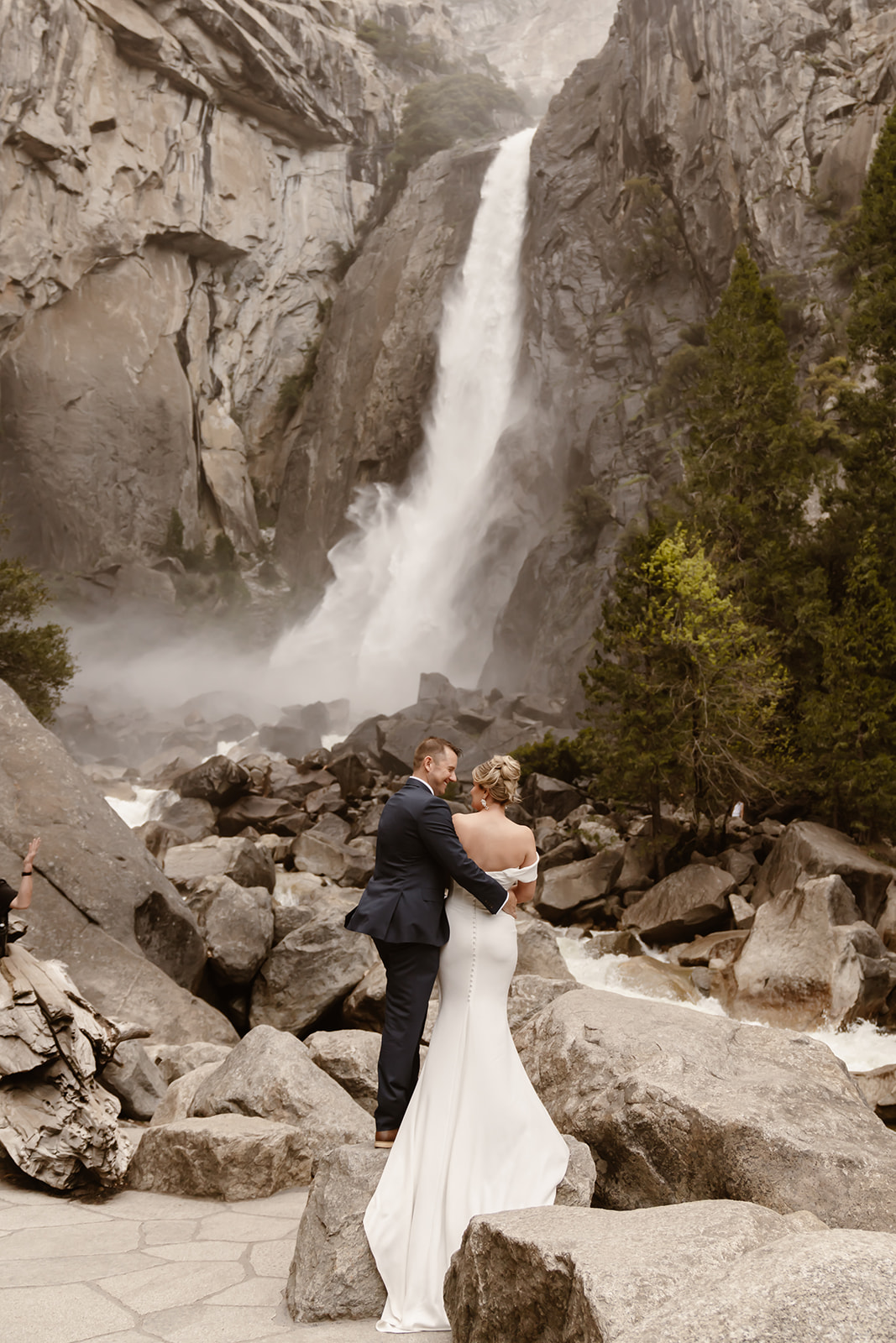 Couple admires waterfall at Yosemite National Park