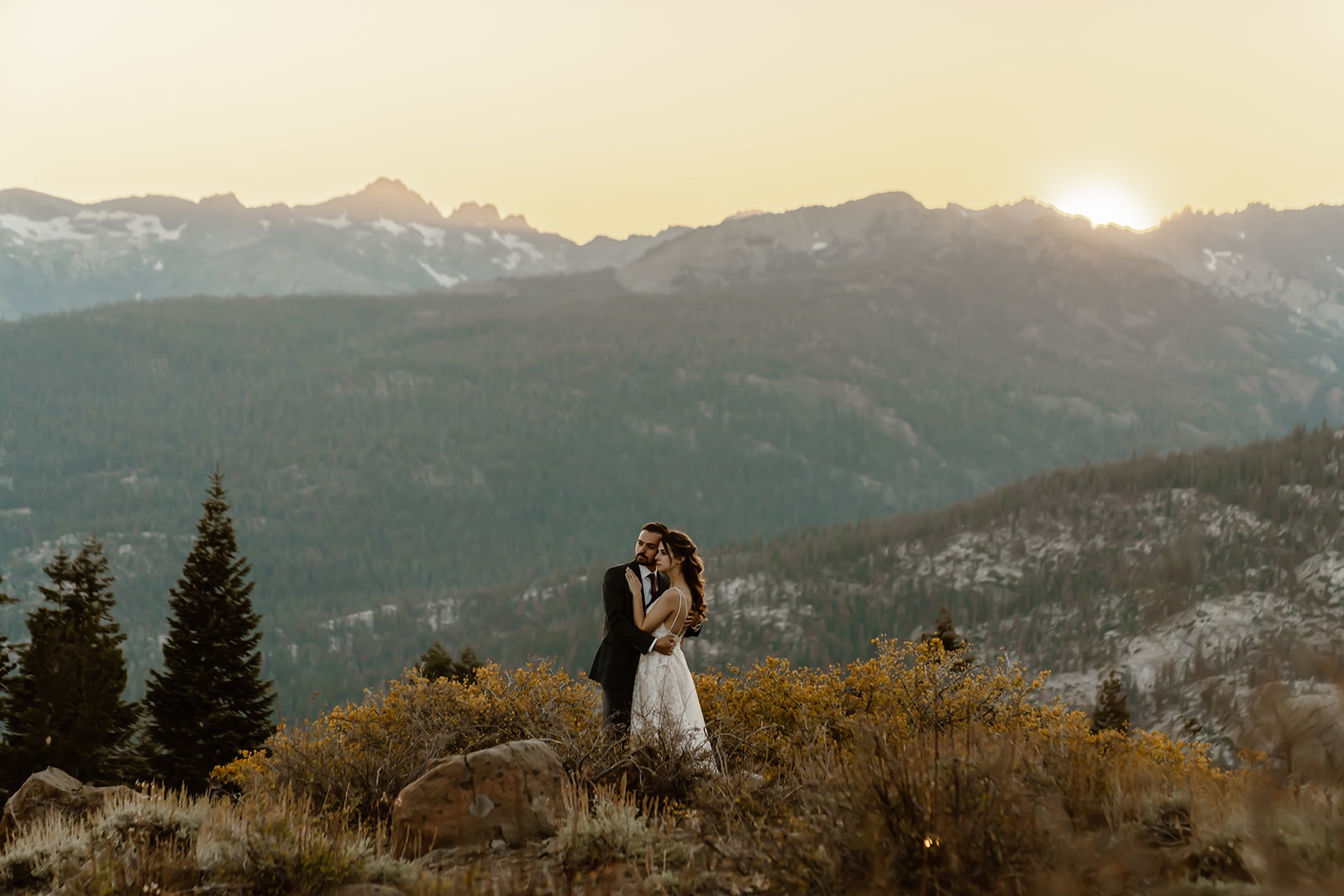 Couple takes in the sunset view during their destination elopement